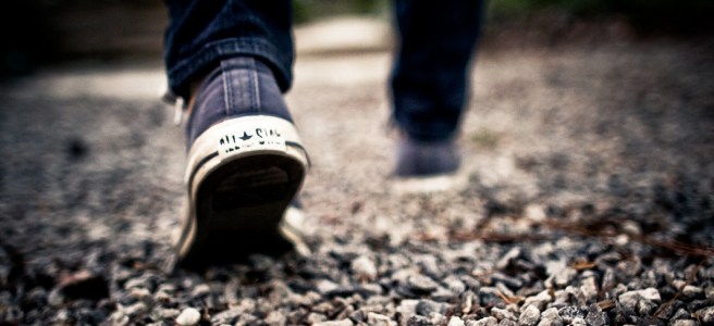 man walking on gravel
