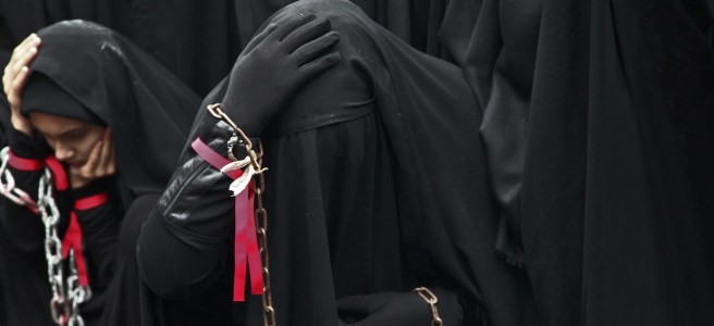 Muslim woman mourning in black niqabs.